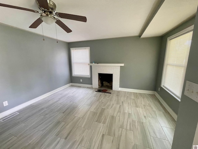 429 S 2nd St, Mayfield, KY 42066 - unfurnished living room with baseboards, a brick fireplace, light wood-type flooring, and a ceiling fan