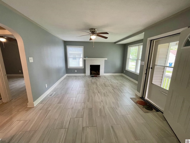 429 S 2nd St, Mayfield, KY 42066 - unfurnished living room with wood finish floors, baseboards, ceiling fan, and arched walkways