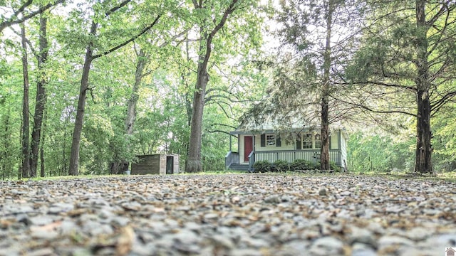 110 Clark Ln, Paducah, KY 42003 - view of front of home with a porch, a view of trees, an outbuilding, and a storage unit
