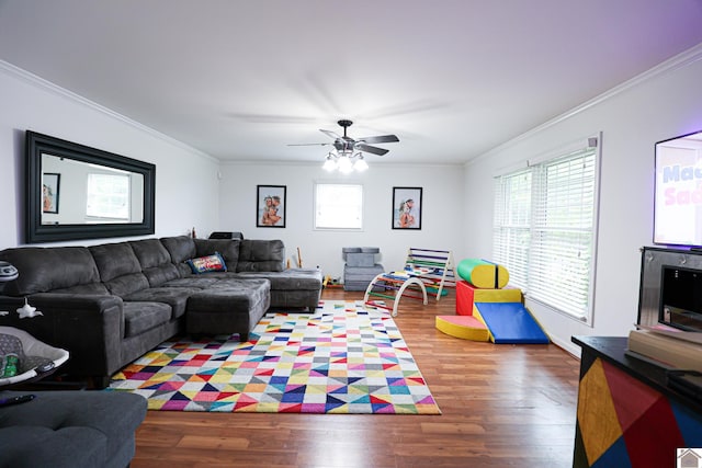 living area with crown molding, ceiling fan, and wood finished floors