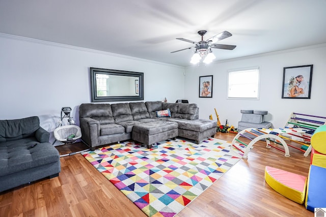 living room featuring a ceiling fan, crown molding, and wood finished floors