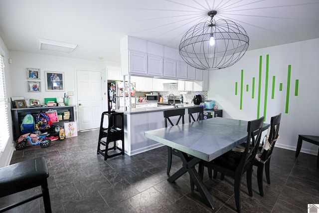 dining space featuring a wealth of natural light and a notable chandelier