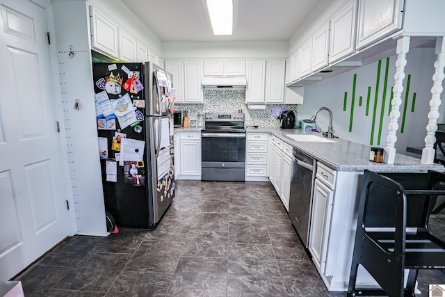 kitchen featuring under cabinet range hood, a sink, white cabinetry, backsplash, and appliances with stainless steel finishes