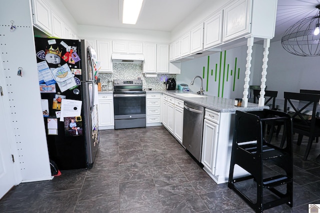 kitchen with a sink, white cabinetry, under cabinet range hood, light countertops, and appliances with stainless steel finishes