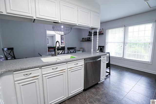 kitchen with a sink, stainless steel dishwasher, baseboards, and white cabinets