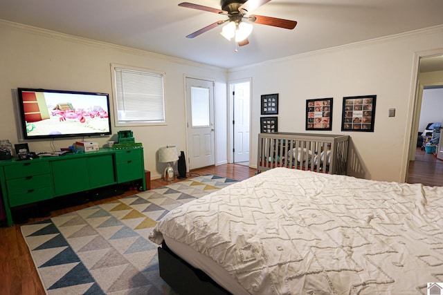 bedroom featuring crown molding, baseboards, ceiling fan, and wood finished floors