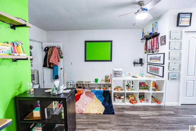 game room featuring baseboards, a ceiling fan, and wood finished floors