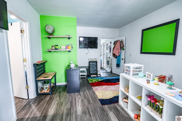 playroom featuring baseboards and wood finished floors