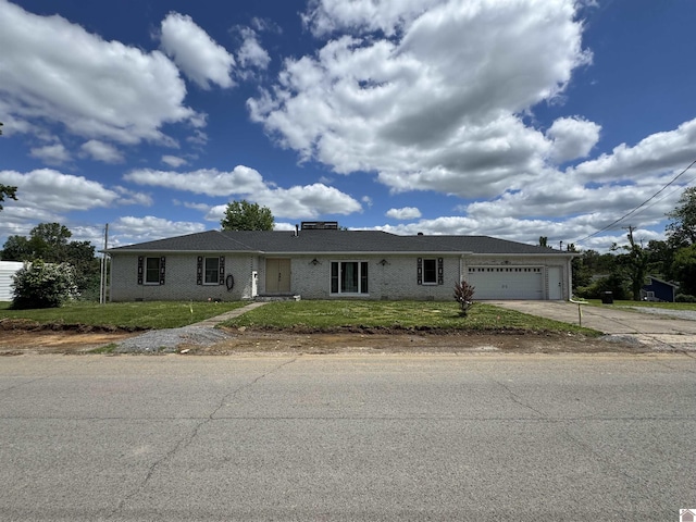 ranch-style home with an attached garage, concrete driveway, brick siding, and a front lawn