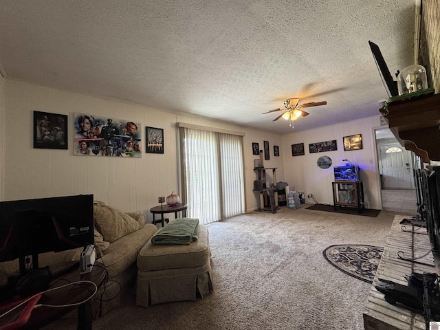 carpeted living room featuring a textured ceiling and a ceiling fan