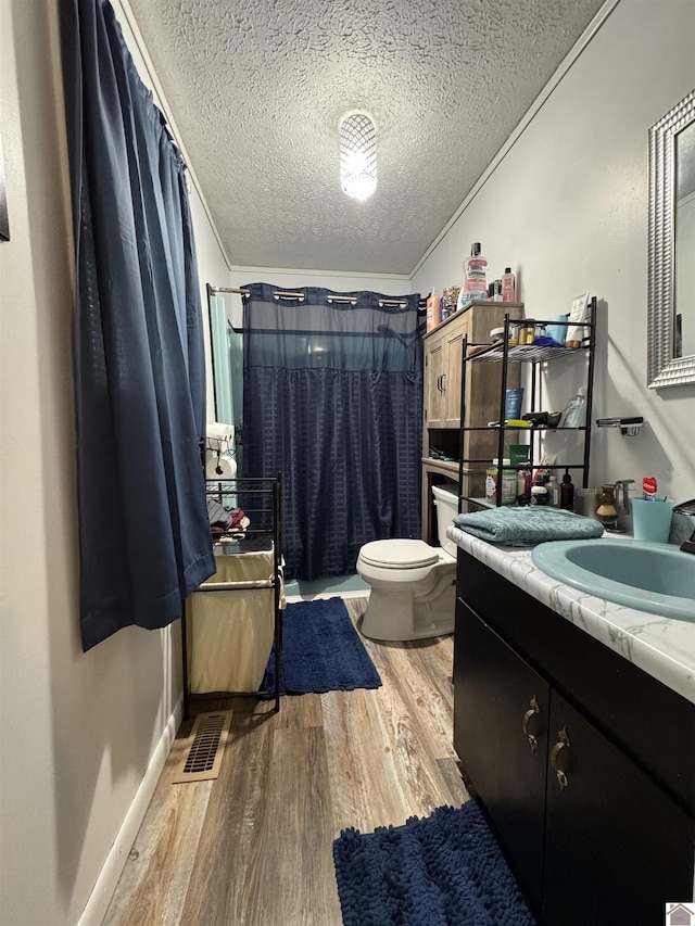 full bathroom with a textured ceiling, visible vents, wood finished floors, and toilet