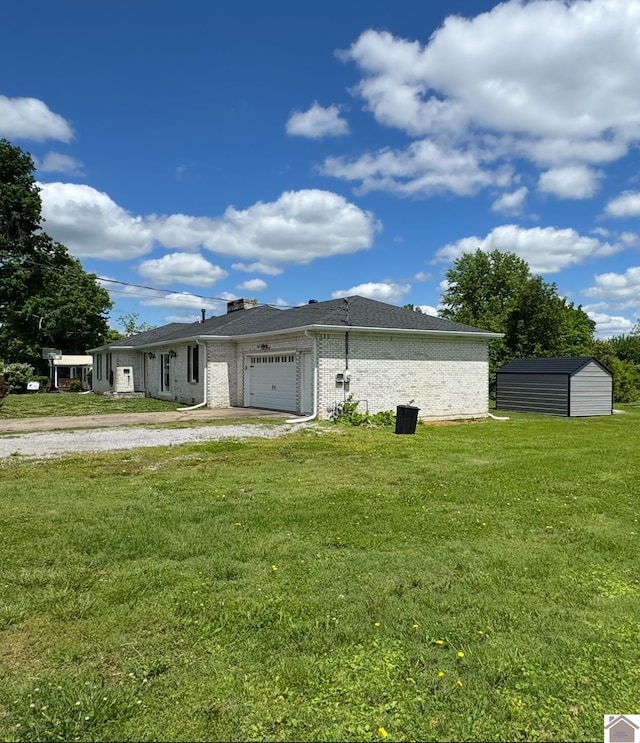 view of side of home with an attached garage, a lawn, an outdoor structure, a shed, and brick siding