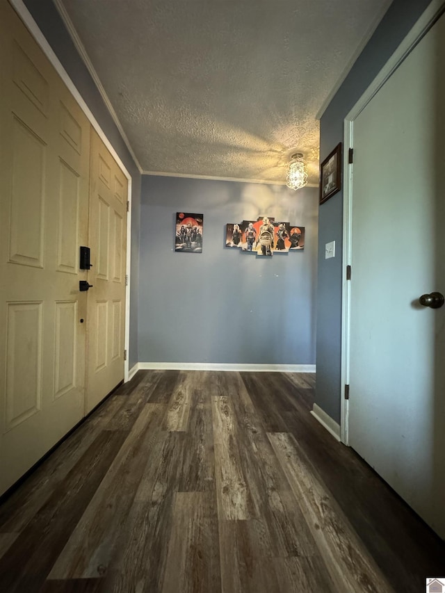 interior space with baseboards, dark wood-style flooring, and a textured ceiling