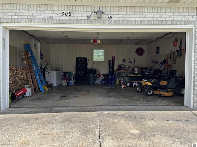 garage with driveway and a garage door opener