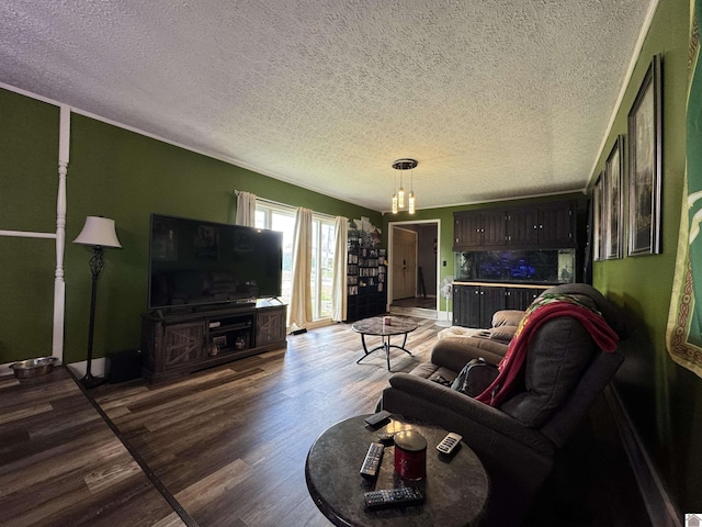 living room featuring a textured ceiling, baseboards, and wood finished floors