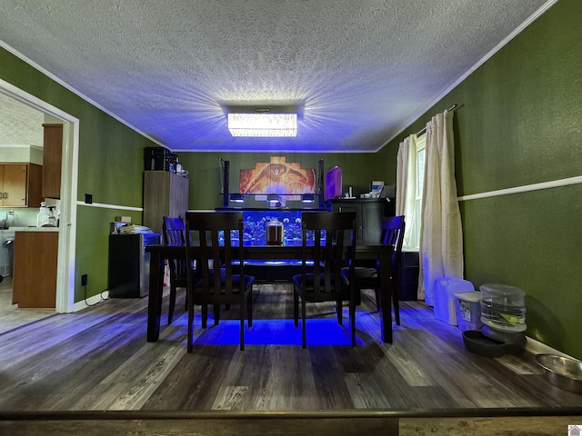 dining room with ornamental molding, a textured ceiling, and wood finished floors