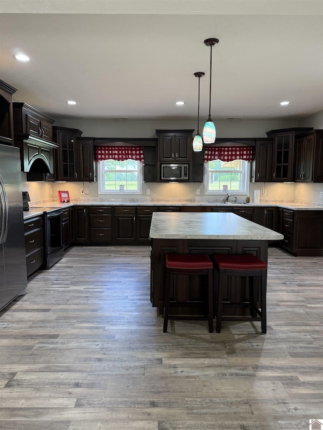 1040 Lone Valley Rd, Calvert City, KY 42029 - kitchen featuring stainless steel appliances, light wood-style flooring, glass insert cabinets, a sink, and recessed lighting