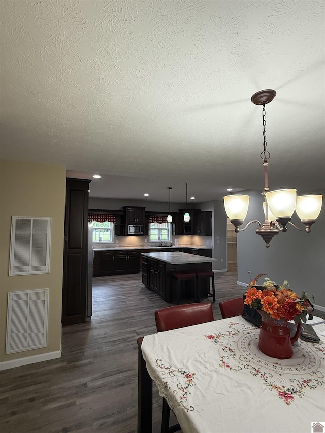 1040 Lone Valley Rd, Calvert City, KY 42029 - dining room with baseboards, dark wood-type flooring, a textured ceiling, and recessed lighting
