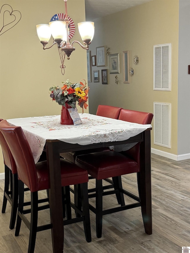 1040 Lone Valley Rd, Calvert City, KY 42029 - dining room featuring wood finished floors, baseboards, and a chandelier