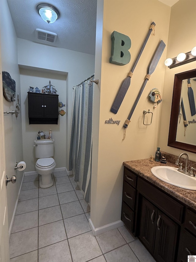 1040 Lone Valley Rd, Calvert City, KY 42029 - bathroom with tile patterned floors, toilet, vanity, a textured ceiling, and baseboards