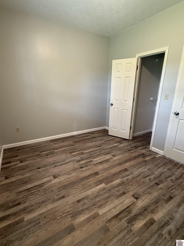 1040 Lone Valley Rd, Calvert City, KY 42029 - spare room featuring dark wood-style floors and baseboards