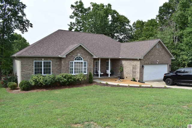 ranch-style house with roof with shingles, brick siding, a front lawn, an attached garage, and driveway