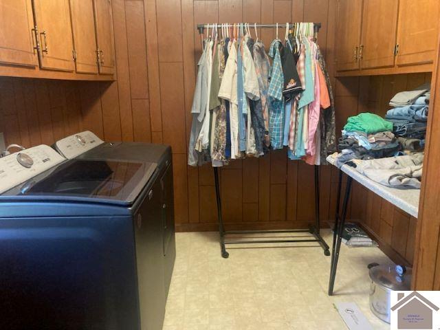 107 Monroe, Fancy Farm, KY 42039 - laundry room featuring separate washer and dryer, wood walls, light flooring, and cabinet space