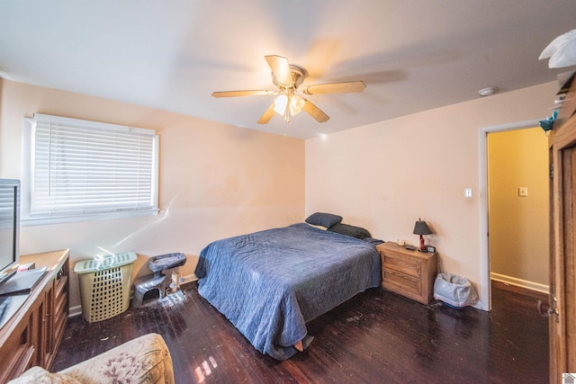 bedroom with wood finished floors, baseboards, and ceiling fan