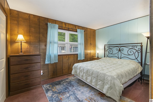 carpeted bedroom with wooden walls