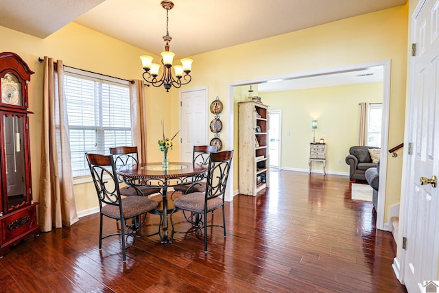 dining area featuring a chandelier, dark wood-type flooring, and plenty of natural light