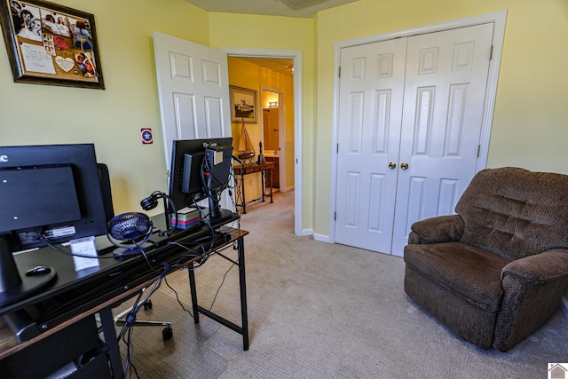 office space featuring light carpet and baseboards
