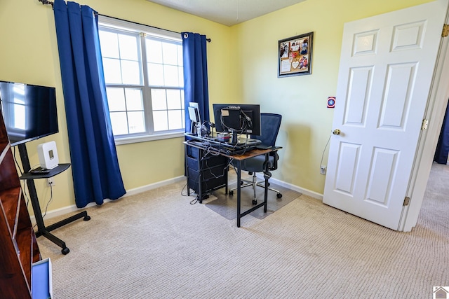 carpeted home office featuring baseboards