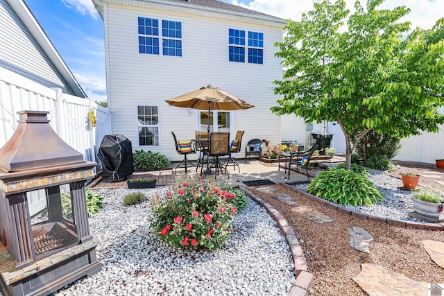 back of property featuring a patio and fence