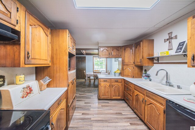 2782 Foust Sledd Rd, Benton, KY 42025 - kitchen featuring dishwasher, a sink, light wood-style flooring, brown cabinetry, and light countertops