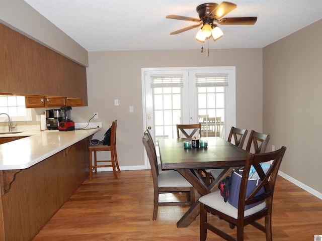 222 Ash St, Benton, KY 42025 - dining area featuring light wood finished floors, ceiling fan, and baseboards