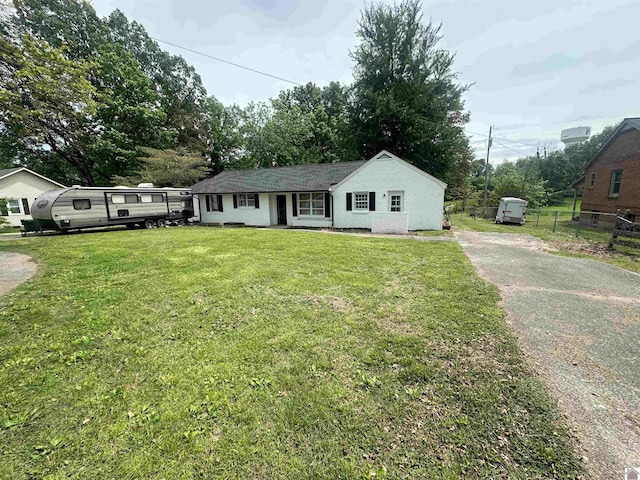 ranch-style home featuring asphalt driveway