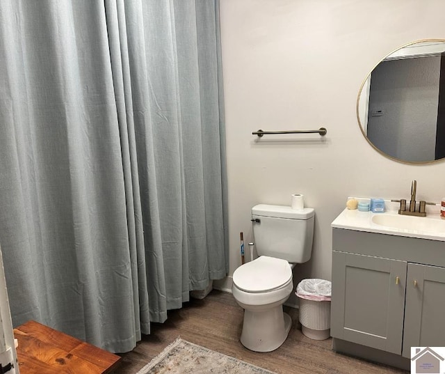 203 N 17th, Murray, KY 42071 - bathroom with wood finished floors, toilet, and vanity