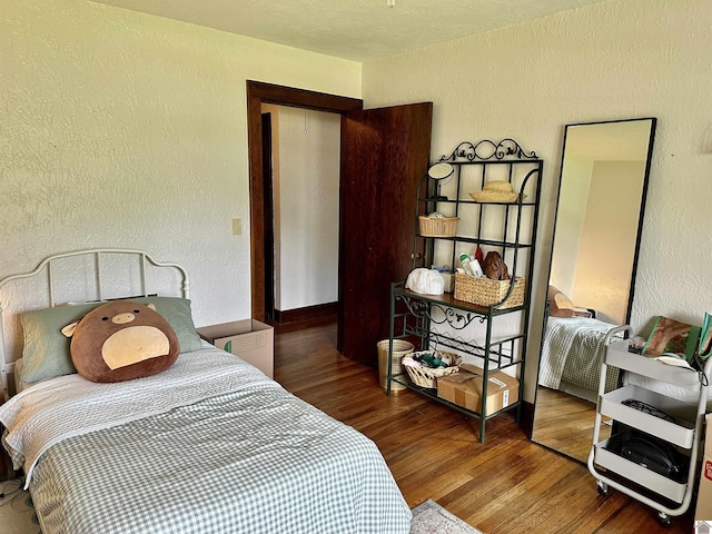 203 N 17th, Murray, KY 42071 - bedroom featuring a textured wall and wood finished floors