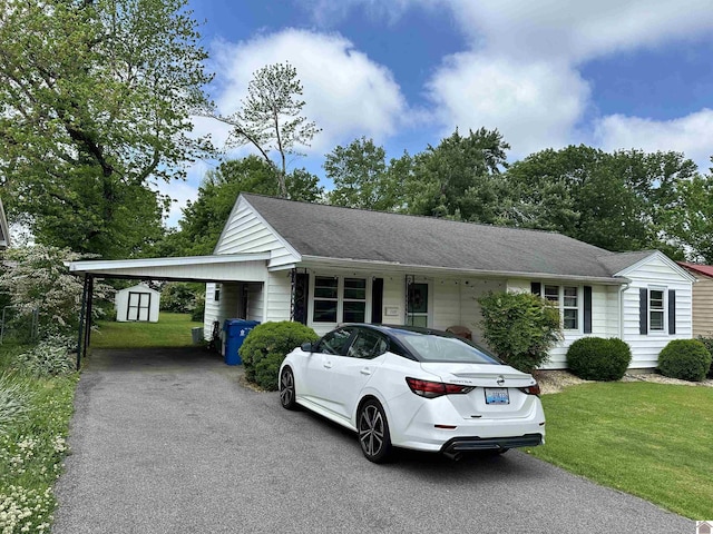 203 N 17th, Murray, KY 42071 - ranch-style home with asphalt driveway, a storage shed, a front yard, an outdoor structure, and an attached carport