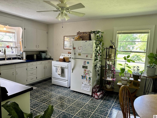 203 N 17th, Murray, KY 42071 - kitchen featuring white appliances, a sink, dark countertops, a textured ceiling, and white cabinetry