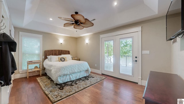 171 Cagel, Gilbertsville, KY 42044 - bedroom featuring a tray ceiling, access to outside, hardwood / wood-style floors, baseboards, and a ceiling fan