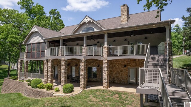 171 Cagel, Gilbertsville, KY 42044 - back of house featuring stairs, a ceiling fan, a patio, stone siding, and a sunroom