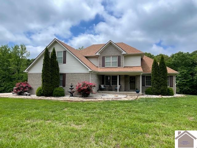 695 Heritage Trce, Cadiz, KY 42211 - traditional-style house with a front lawn and covered porch