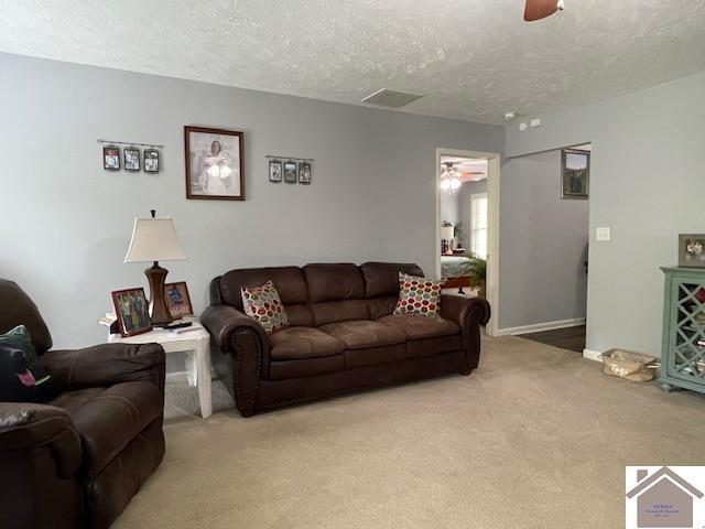 695 Heritage Trce, Cadiz, KY 42211 - living area with ceiling fan, light colored carpet, a textured ceiling, and baseboards