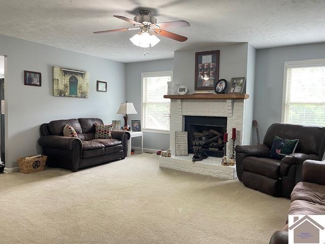 695 Heritage Trce, Cadiz, KY 42211 - carpeted living area featuring plenty of natural light, a ceiling fan, baseboards, a fireplace, and a textured ceiling
