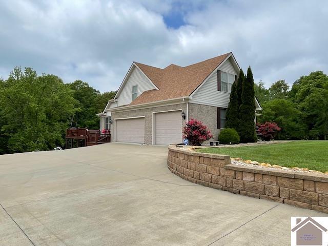695 Heritage Trce, Cadiz, KY 42211 - view of side of home with driveway, a yard, and a garage
