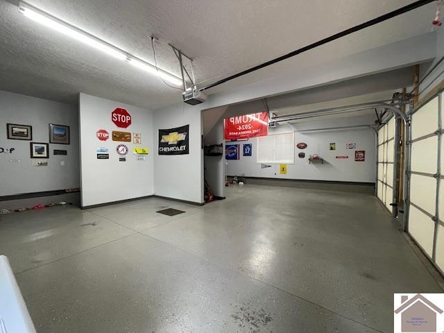 695 Heritage Trce, Cadiz, KY 42211 - garage featuring a garage door opener and baseboards