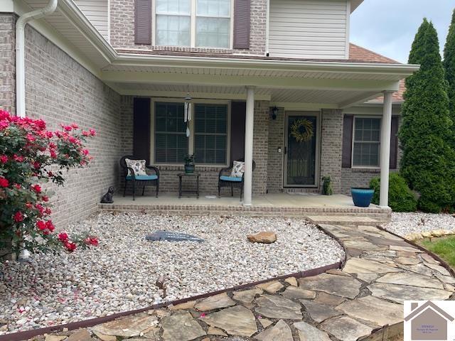 695 Heritage Trce, Cadiz, KY 42211 - doorway to property featuring covered porch and brick siding