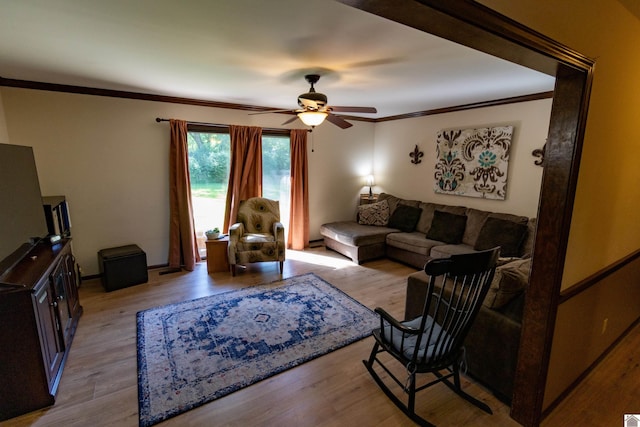 living room with ceiling fan, wood finished floors, and crown molding