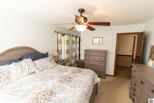 bedroom featuring light carpet and a ceiling fan